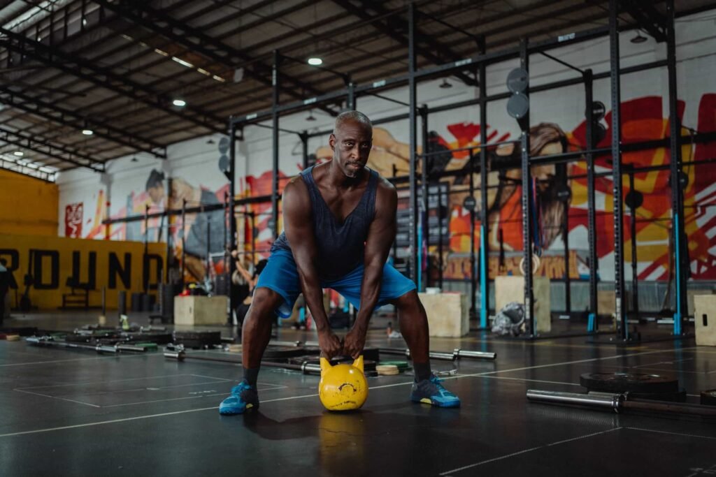 man lifting a soft kettlebell