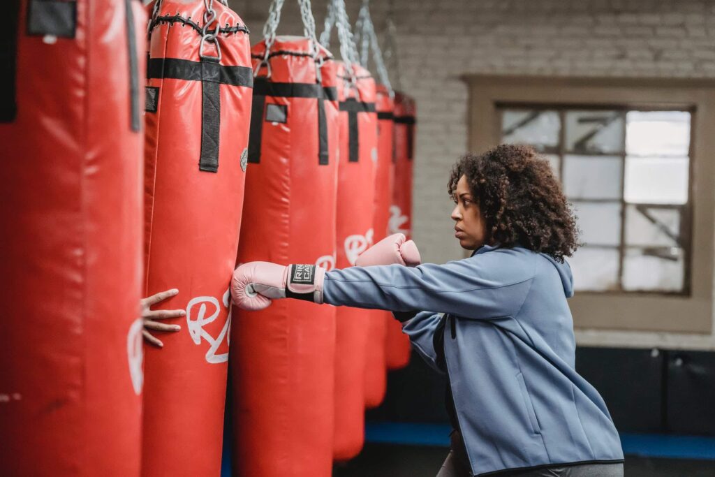 a woman sparring with a custom punching bag