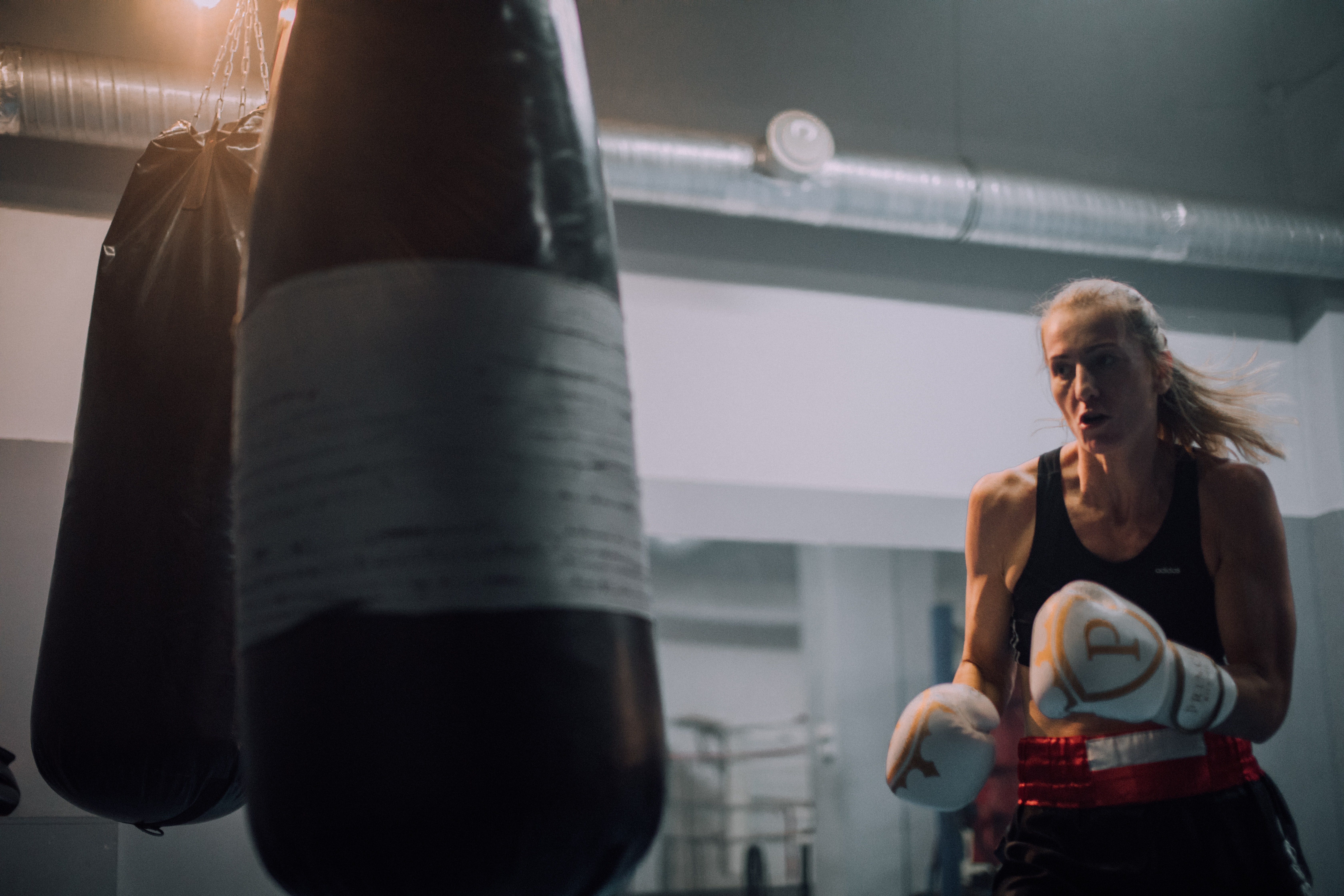 An image of a girl using punching bag for home