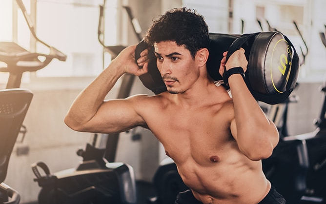 A man works out with weight bag training.