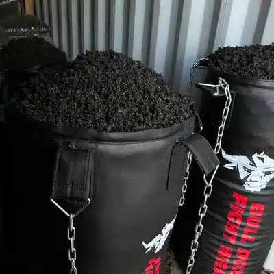 A punching bag filling with recycled rubber mulch.