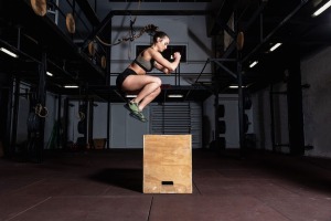 A woman engaging in a jump box workout.