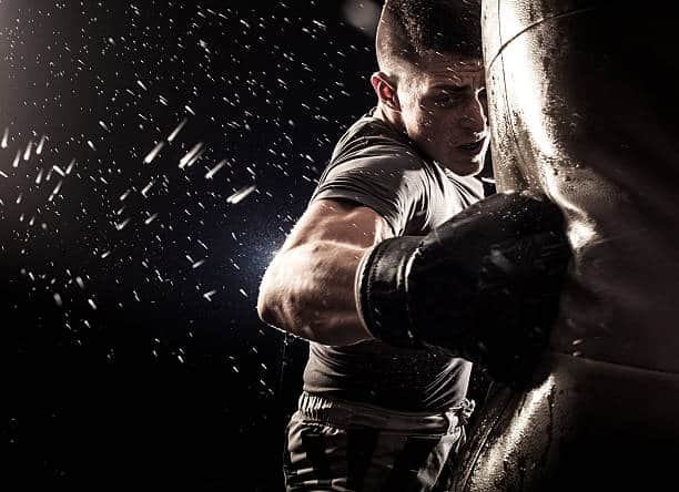 A man boxing at the punching bag.