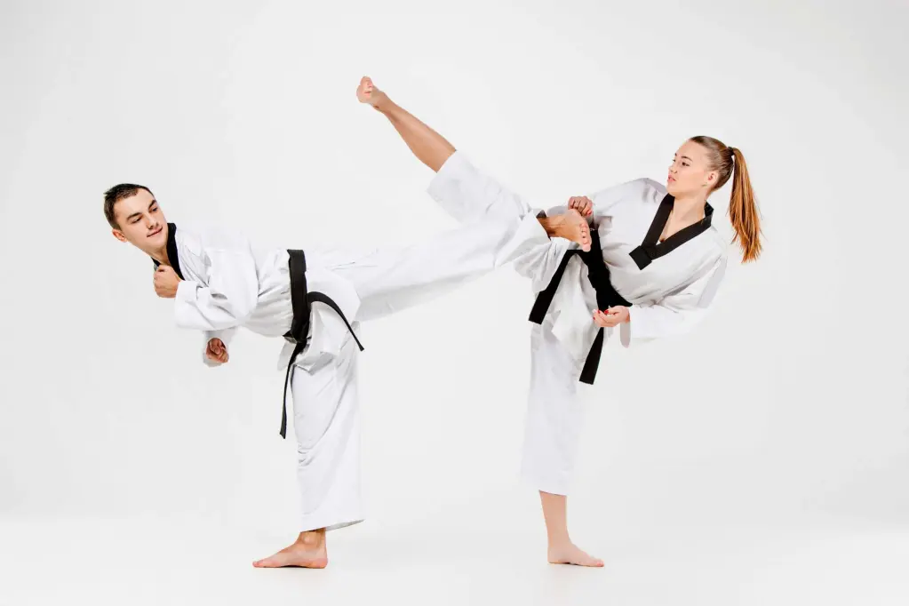 Two athletesin a taekwondo sparring session wearing taekwondo sparring gear