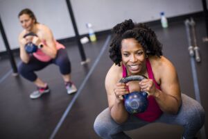 Women working out with a kettlebell set