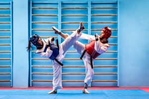 Two athletes wearing taekwondo sparring gear set