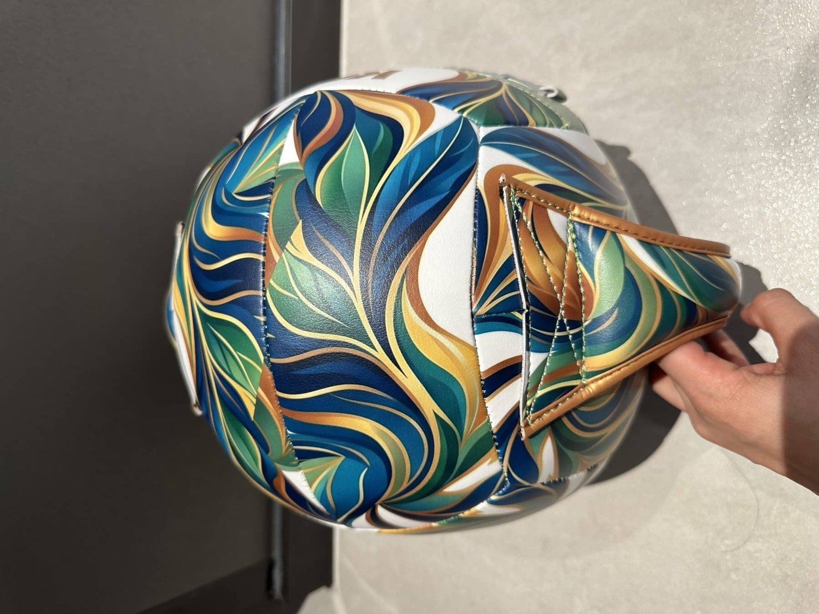 Custom handle wall ball side view with synthetic shell and patterned panels