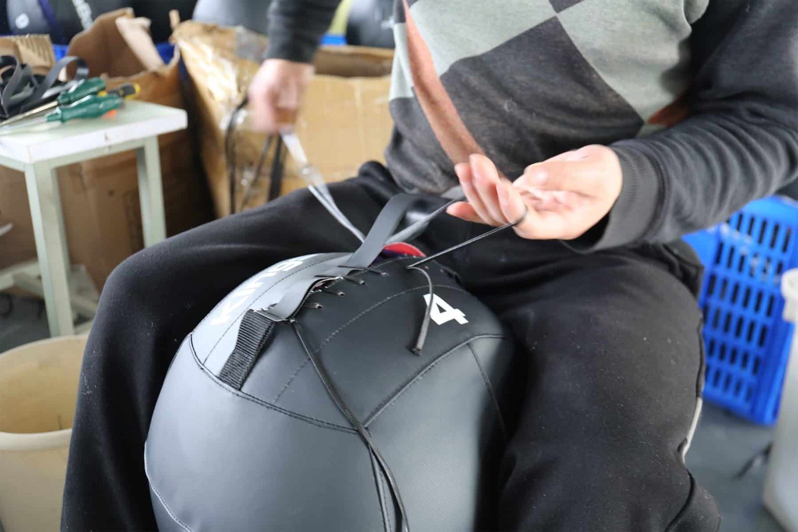 Black 4 kg wall ball showing stitching and closure details for sample approval