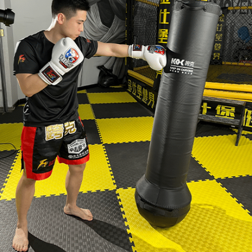 An image of a man throwing punches towards a punching bag